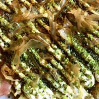 Okonomiyaki - Osaka Style · This classic Japanese savory pancake is filled with fresh cabbage and scallions, topped with...