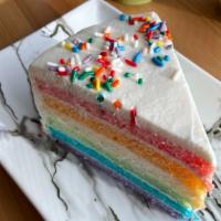 Rainbow Cake · Rainbow colored vanilla sponge cake with light cream-cheese frosting. Sprinkled with Macaron...