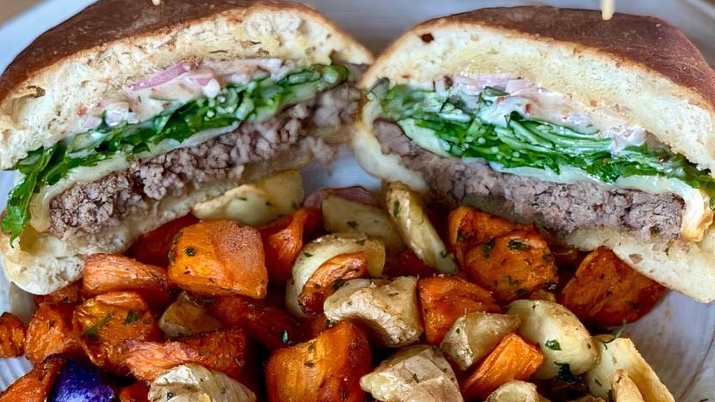 Zulu Burger · Grass fed Angus beef burger topped with Muenster cheese, arugula, pickled shallots and bacon aioli on a ciabatta bun. Comes with a side of tri-colored potatoes.