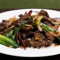 Mongolian Beef · Spicy. Yellow and green onion, chili pods, and house sauce over crispy rice noodles.