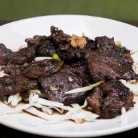 Shandong Beef · Marinated flank steak, garlic soy, and bed of fresh cabbage.