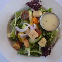 Side Garden Salad · Mixed greens, tomato, cucumber, red onion, croutons, and our house champagne vinaigrette