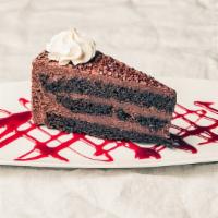 Chocolate Layer Cake Slice · Rich chocolate cake layered with decadent chocolate ganache topped with fresh whipped cream