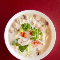Tom Kha Soup · The most famous hot and sour soup with mushrooms, onions,tomatoes, galangal, kaffir lime lea...
