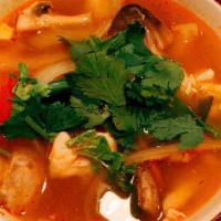 Tom Yum Soup · The most famous hot and sour soup with mushrooms, onions, tomatoes, galangal, kaffir lime le...