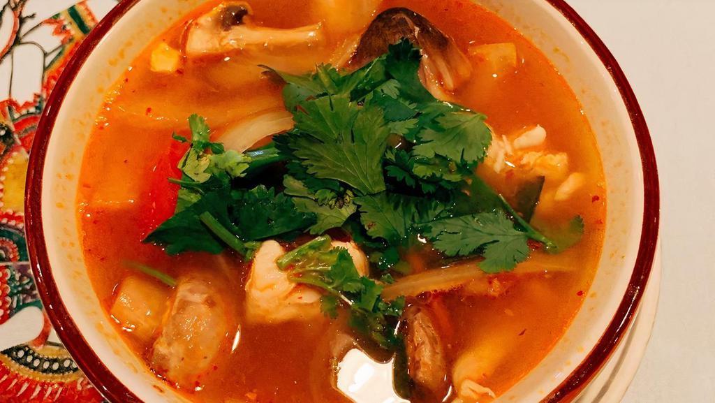 Tom Yum Soup · The most famous hot and sour soup with mushrooms, onions, tomatoes, galangal, kaffir lime leaf and lemongrass.