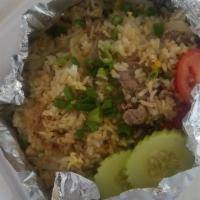 Thai Fried Rice · Stir-fried jasmine rice with meat, egg, onions, green peas and tomatoes.
