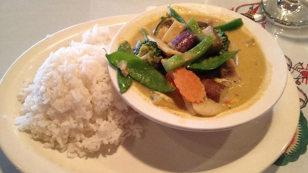 Green Curry · Medium green curry in coconut milk with bell peppers, bamboo shoot, green peas, zucchini and Thai basil. Includes steamed jasmine rice.