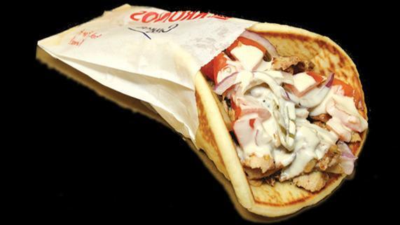Chicken Shawarma Wrap · A mixture of marinated chicken breast and thighs cooked to perfection on a rotisserie against a vertical flame. Served with onions, tomatoes, pickles, tahini and garlic sauce on pita bread.