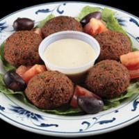 Falafel (5) · Vegetarian. Ground and seasoned chickpeas and other vegetables shaped into balls and fried.