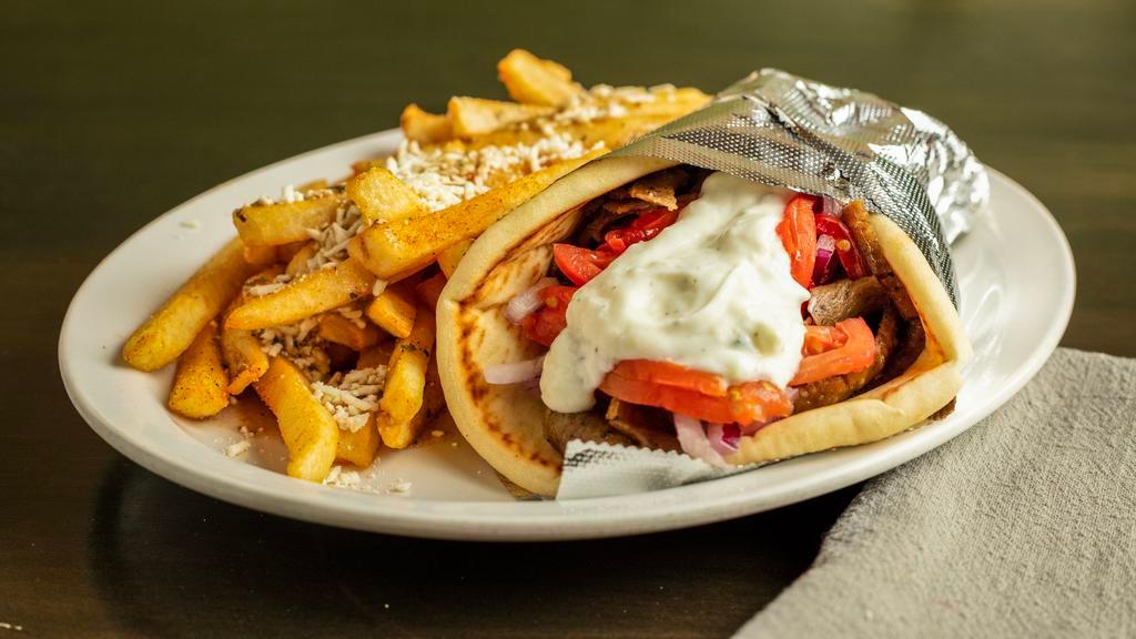 Original Gyro Wrap · A mixture of marinated and seasoned beef and lamb cooked to perfection on a rotisserie against a vertical flame. Served with tomatoes, onions and tzatziki sauce on pita bread.