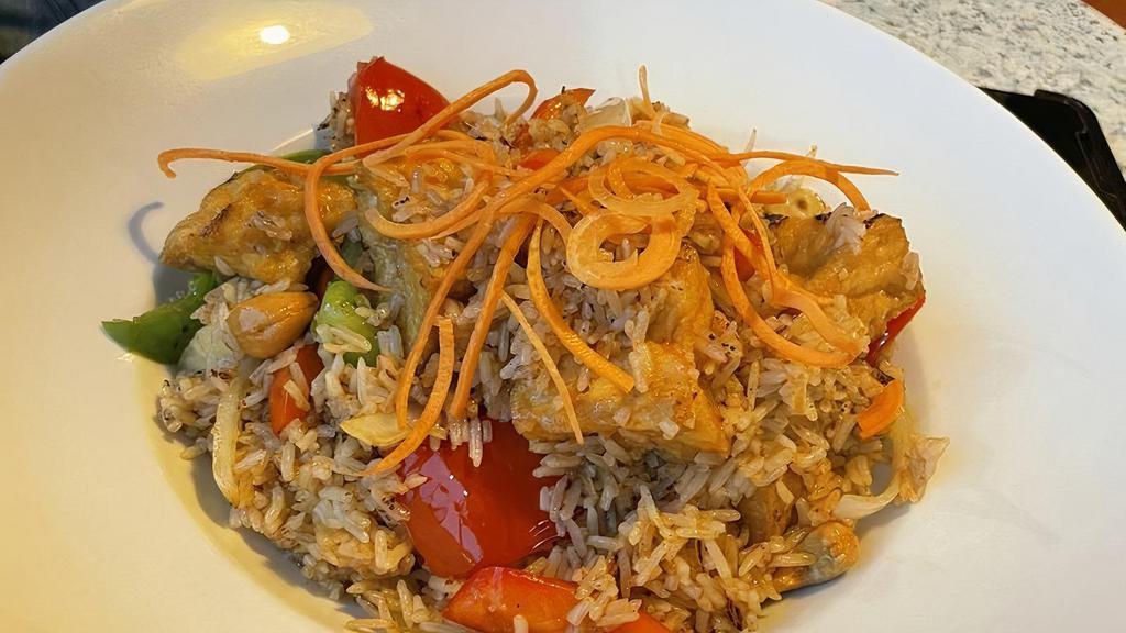 Green Curry Fried Rice · Jasmine fried rice with green curry sauce, Thai basil, peas and carrots, and bamboo shoot.