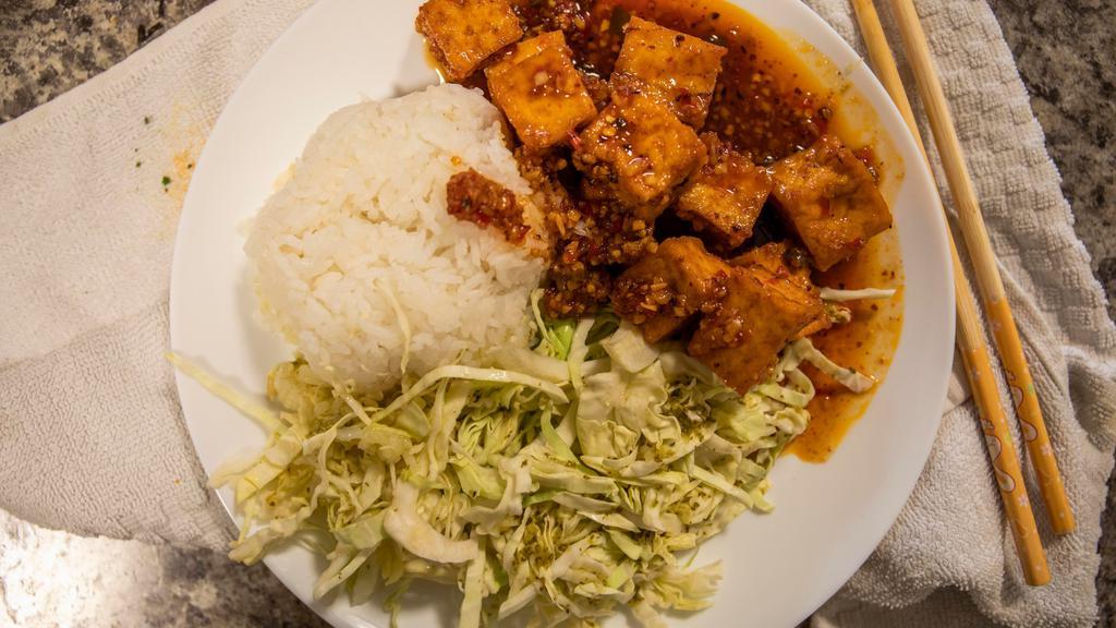 Spicy Tofu Scampi · deep-fried tofu sautéed with garlic, white wine, and sweet chili sauce, topped w/ spicy cabbage coleslaw.