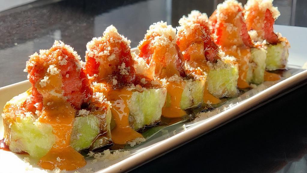 Fuji Roll · Yellowtail, spicy crab, avocado, jalapeno in soy paper topped w/ spicy tuna, spicy mayo, eel sauce, crunch.