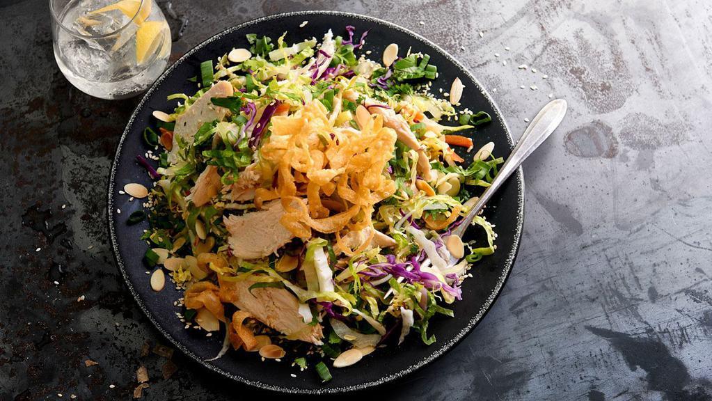 Asian Grilled Chicken Salad · Grilled chicken with crunchy noodles, almonds, sesame seeds, green onions, carrots and cilantro, tossed with sweet and spicy peanut dressing