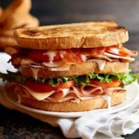 Clubhouse Sandwich · Sliced turkey, ham and smoked bacon topped with provolone and cheddar cheese, fresh greens, ...