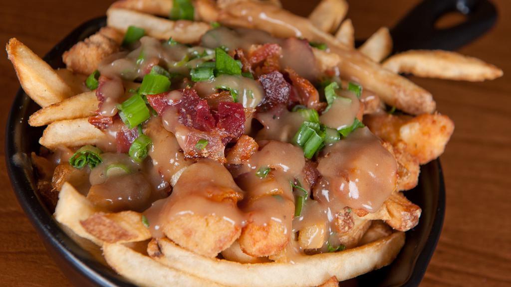 Poutine · Pub fries and cheese curds with ranch seasoning, bacon crumbles, green onions, and beef gravy.