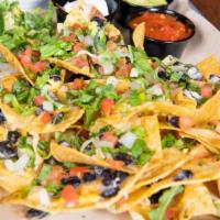 Ale House Nachos · Crispy tortilla chips with melted cheddar and pepper jack cheeses. Topped with black beans, ...