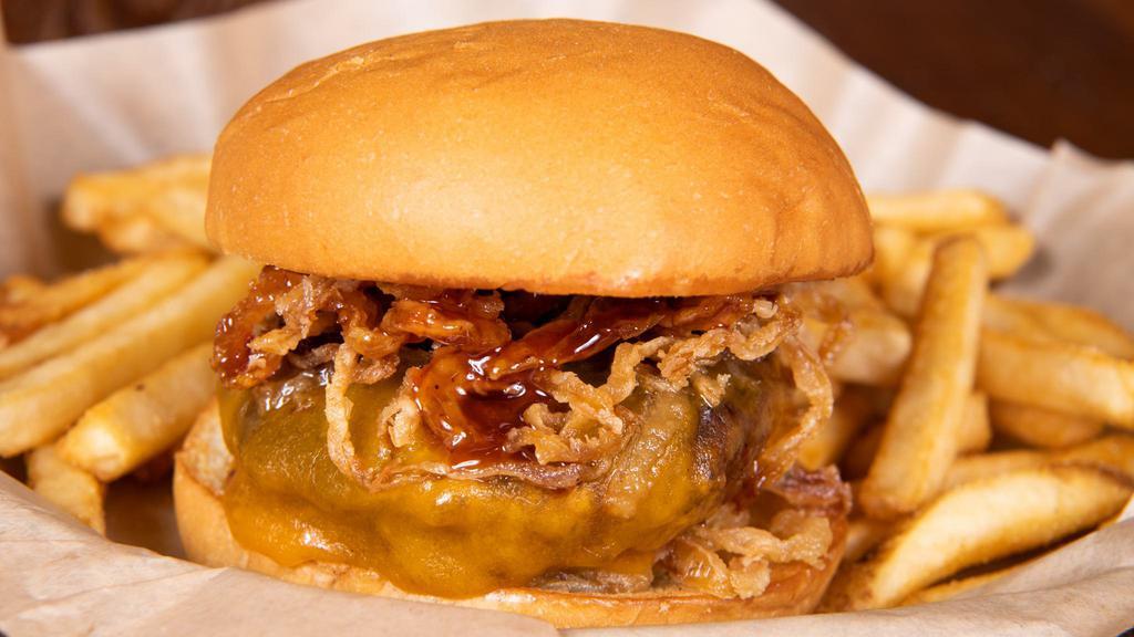 Wrangler Lucy · Stuffed with jalapeños and cheddar, topped with cheddar, bacon, haystack onions, and bourbon molasses sauce.