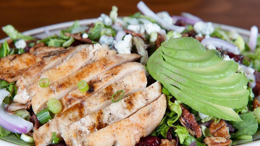 Bourbon Cranberry Chicken Salad · Grilled chicken, spinach, arugula, romaine, red and green onions, bleu cheese, glazed pecans, bourbon-soaked cranberries, bacon, avocado, and drizzled with sweet Vidalia onion dressing.