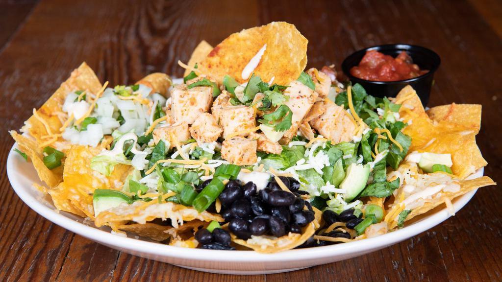 Taco Salad · Gluten-free. Your choice of chipotle chicken or beef with tortilla chips, romaine, pico, avocado, black beans, chipotle ranch, cheddar, pepper jack, onion salsa, green onions, and cilantro. Sub breaded shrimp for an additional charge. Gluten-friendly without chips or shrimp.
