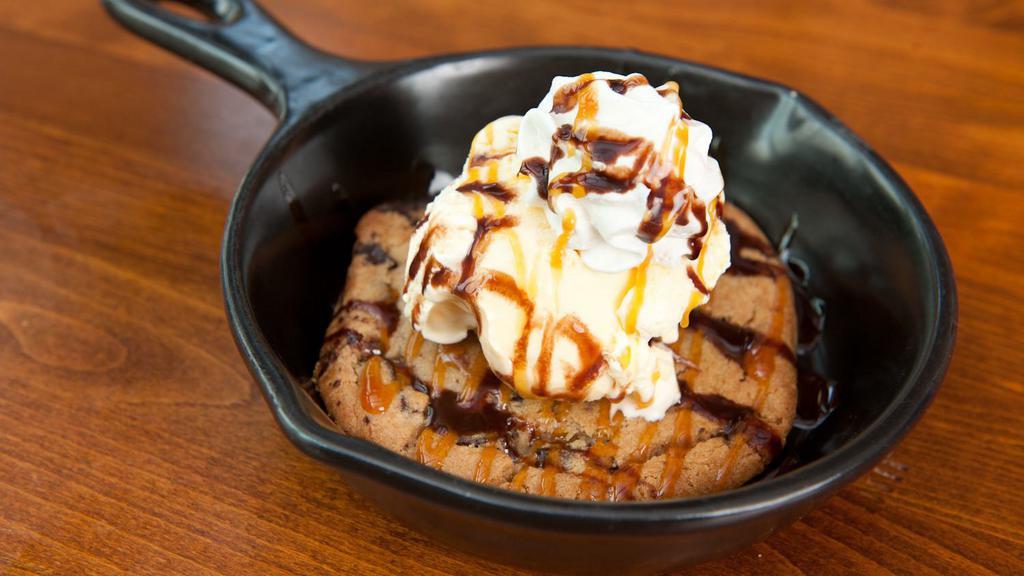 Chocolate Chip Lucy · A large chocolate-chunk cookie stuffed with cream cheese and topped with vanilla ice cream – then topped off with chocolate and caramel sauces and whipped cream.
