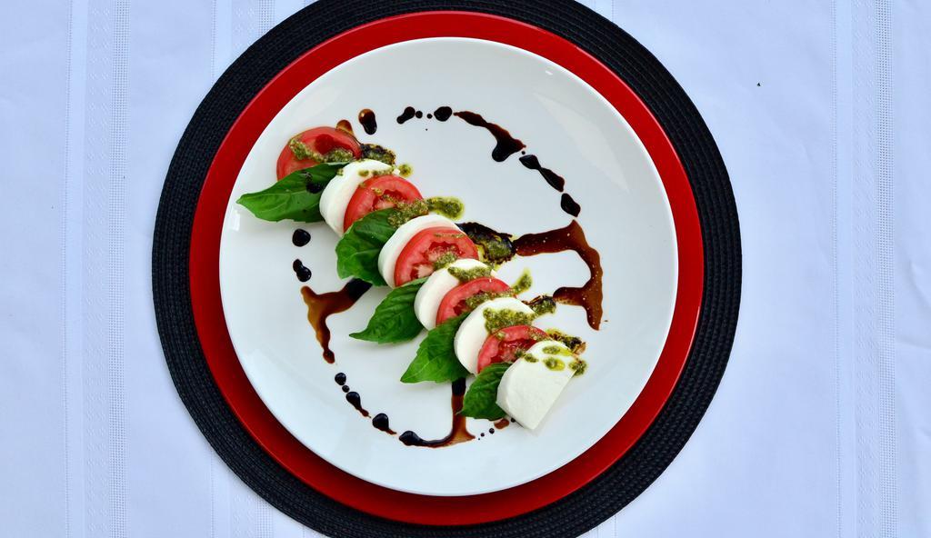 Caprese Salad · Roma Tomato, Fresh Mozzarella, Pesto, Balsamic Glaze.