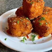 Fried Mac & Cheese Bites · Grandma’s Mac & Cheese, crispy on the outside and gooey on the inside, served with Zesty Ran...