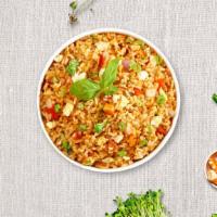 Thai Fried Rice · Stir-fried rice with egg, tomatoes, peas and carrots, onions, topped with chopped cilantro a...