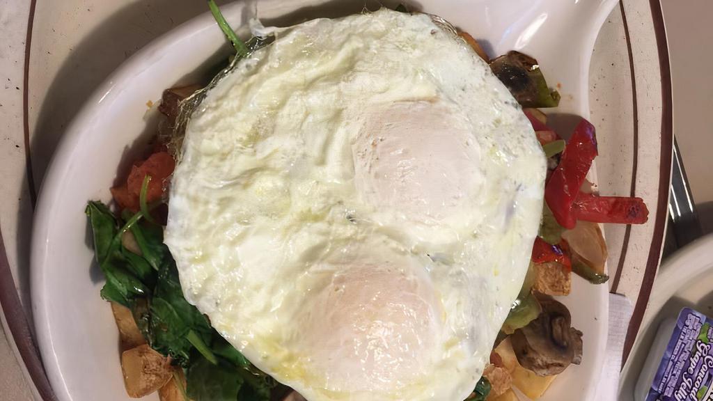 Veggie Skillet · Spinach, mushrooms, bell peppers, onions and tomatoes with hollandaise sauce topped with two eggs any style. Served with choice of toast.