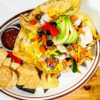 Taco Salad · Large fried flour tortilla shell filled with taco meat and beans. Topped with lettuce, tomat...