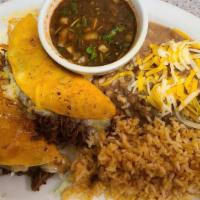 Quesabirra Tacos · Two red stained tortillas with tender shredded beef and Menonita cheese. Served with a tradi...