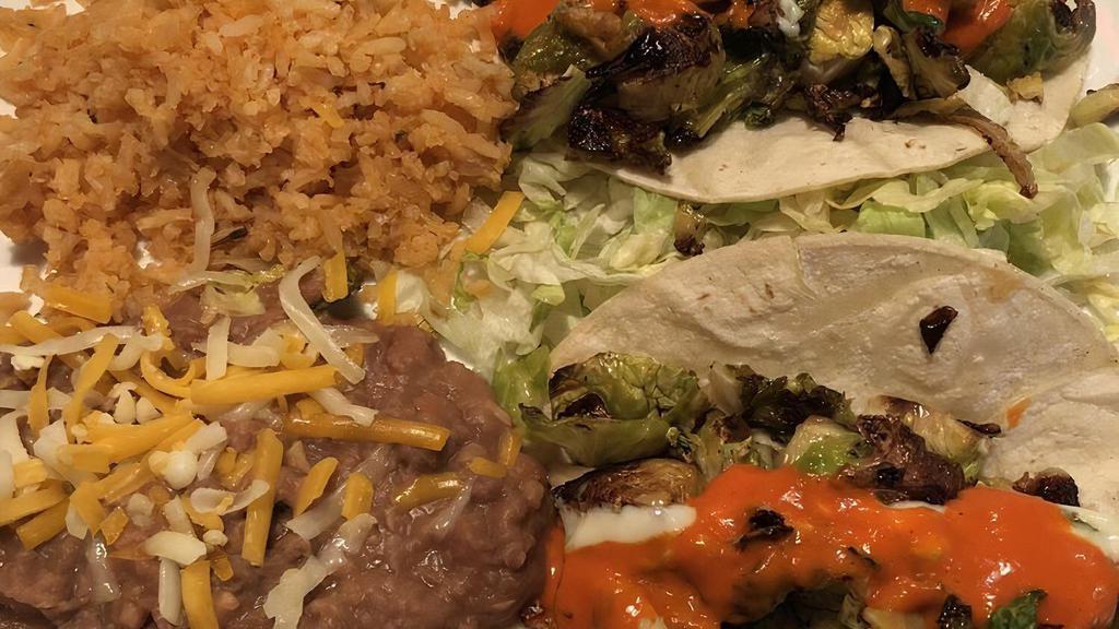 Signature Tacos · Choice of two tacos. Choose from Carnitas (shredded pork and fajita veggies), Fish (sauteed mahi mahi and fajita veggies) or Chili Lime Chicken (Chicken, cabbage, cilantro, and fire roasted tomato salsa. Served with rice and beans.