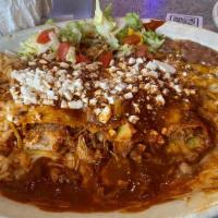 Enchiladas Suizas · Two corn tortillas rolled up with shredded chicken, topped with zesty tomatillo sauce, swiss...