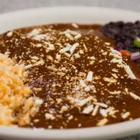 Mole Enchiladas · Two corn tortillas rolled up with shredded chicken, topped with cotija cheese and smothered ...