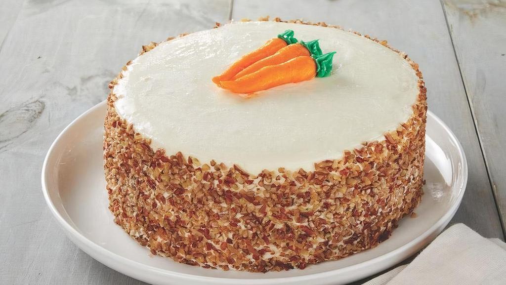 Carrot Cake · Moist cake layers loaded with California's San Joaquin Valley grown carrots, raisins and walnuts and Hawaiian Island pineapple chunks frosted with Wisconsin farm fresh cream cheese icing finished with roasted crushed Georgia pecans.