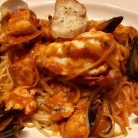Frutti Di Mare · Sauteed Shrimp, fish, mussels and clams with garlic white wine and tomato sauce over a bed o...