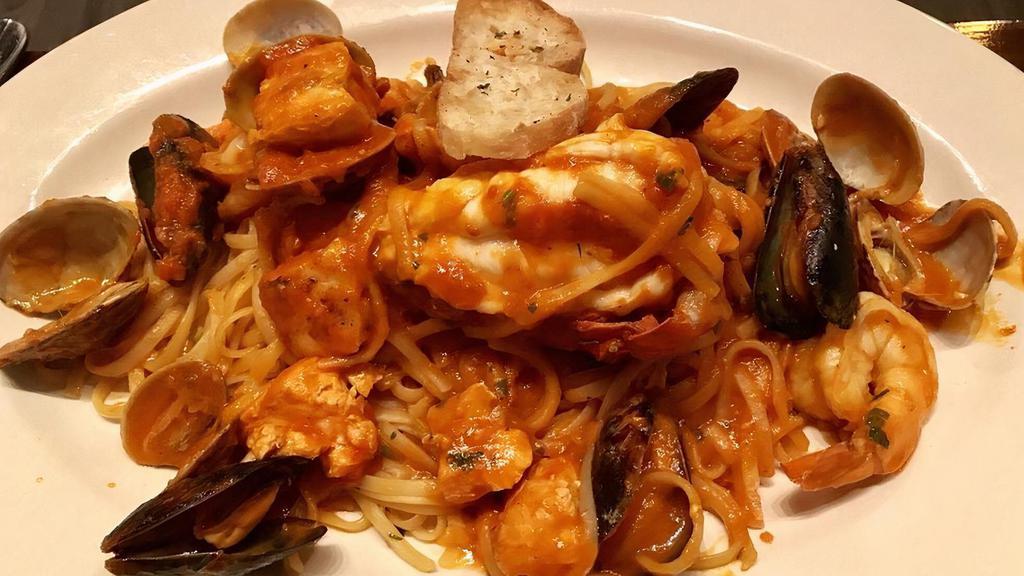 Frutti Di Mare · Sauteed Shrimp, fish, mussels and clams with garlic white wine and tomato sauce over a bed of linguine.
