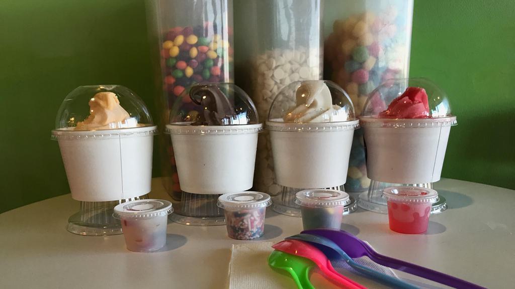 Family 4 Pack · Do you have bored kiddos at home and want something fun to do?!? Let us HELP you!! 
This family pack is sure to please everyone in the family. Your family gets to pick 4- 8 oz cups of yogurt to your liking, and it comes with 4 topping choices as well. It's a family treat ready for you to create!