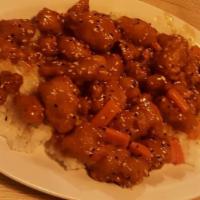Orange Chicken With White Rice · Battered and cooked in a sweet orange sauce.