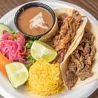 Taco Meal · Two tacos filled with your choice of protein, served with rice, beans and a side salad.