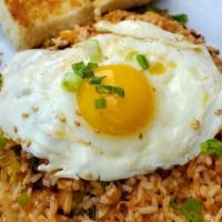 Kimchi Fried Rice.. · Korean scallions, kimchi, chopped bacon. and rice topped with an over easy egg.. Served with...