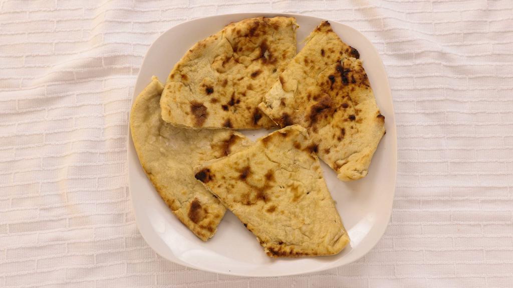 Naan · Tandoori baked soft and puffy bread.