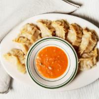 Vegetable Momo (8 Pieces) · Steamed mixed vegetable dumpling with peanuts. Served with a mild or spicy tomato sauce.