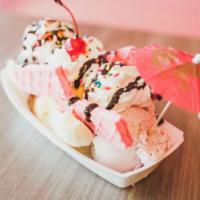 Banana Split · Banana split in half. Three scoops of ice cream with waffle cookies on the side topped with ...