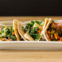 Veggie Tacos · Flour tortillas filled with bell peppers, shredded carrots, mushrooms, scallions and cilantr...