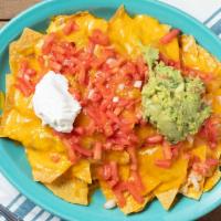 Super Nachos · Chips, beans, choice of chicken, ground beef, or chorizo, topped with cheddar cheese, guacam...