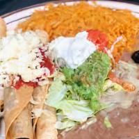 Taquitos Rancheros · Three crisp com tortillas filled with your chicken or shredded beef, served with lettuce, pi...