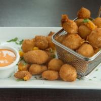 Cheese Curds · Breaded and fried Wisconsin cheddar cheese curds, with tapatio dipping sauce.