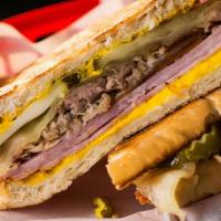 Classic Cubano · Roasted pork, hickory smoked ham, Swiss cheese, dill pickles, mayo-mustard sauce on toasted ...